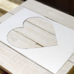 sticking-heart-shaped-stencil-to-wood